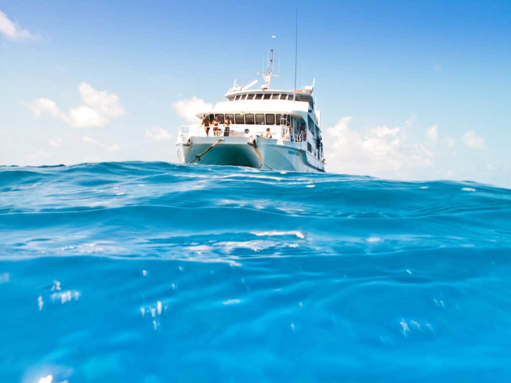 Great Barrier Reef catamaran sails on clear blue water
