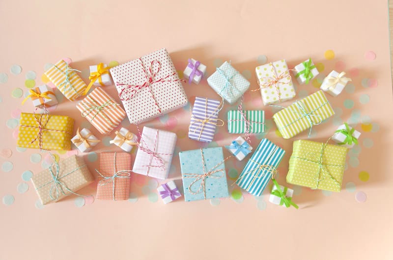 Gifts wrapped in pastel colored paper with small ribbons.